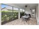 Covered patio area with dining table, grill, and views of the landscaped yard at 8219 Summer Brook Ct, Land O Lakes, FL 34638