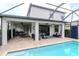 Spacious screened-in pool area with covered patio and outdoor dining and seating areas at 8219 Summer Brook Ct, Land O Lakes, FL 34638