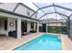 Outdoor living space with pool, covered patio, and modern outdoor furniture at 8219 Summer Brook Ct, Land O Lakes, FL 34638