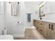 Modern bathroom featuring a rustic vanity, hexagon tile flooring and updated fixtures at 8240 Jacaranda Ave, Seminole, FL 33777