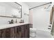 Modern bathroom with a dark wood vanity, quartz countertop, and subway tile shower at 8240 Jacaranda Ave, Seminole, FL 33777