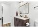 Stylish half-bath with dark wood vanity, white quartz countertop, and bronze fixtures at 8240 Jacaranda Ave, Seminole, FL 33777