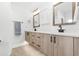 Bright bathroom with a rustic double vanity, hexagon tile flooring and updated fixtures at 8240 Jacaranda Ave, Seminole, FL 33777