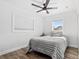 Cozy bedroom with natural light, a ceiling fan and wood-look flooring at 8240 Jacaranda Ave, Seminole, FL 33777