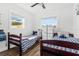 Shared bedroom space with two beds, a ceiling fan, and plenty of natural light at 8240 Jacaranda Ave, Seminole, FL 33777
