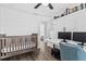 Bedroom-style bedroom featuring a crib and workstation with natural light at 8240 Jacaranda Ave, Seminole, FL 33777