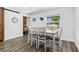 Cozy dining area with a rustic barn door, white table and chairs and lots of light at 8240 Jacaranda Ave, Seminole, FL 33777
