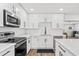 Modern kitchen featuring white cabinets, sleek countertops, and stainless steel appliances at 8240 Jacaranda Ave, Seminole, FL 33777