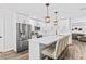Spacious kitchen featuring white cabinets, stainless steel appliances, and a breakfast bar at 8240 Jacaranda Ave, Seminole, FL 33777