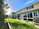 Spacious backyard featuring a full-length screened-in porch and well-maintained lawn at 11246 Kapok Grand Cir, Madeira Beach, FL 33708
