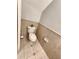 Compact bathroom features neutral tiles, standard toilet and fixtures, providing essential comfort at 11246 Kapok Grand Cir, Madeira Beach, FL 33708