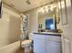 A well-lit bathroom with a shower-tub combination and a white vanity at 11246 Kapok Grand Cir, Madeira Beach, FL 33708