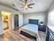 Bedroom with wood floor, a blue bed, and a connected bathroom at 11246 Kapok Grand Cir, Madeira Beach, FL 33708
