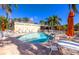 Inviting community pool surrounded by lounge chairs and umbrellas, ideal for relaxation and leisure at 11246 Kapok Grand Cir, Madeira Beach, FL 33708