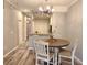 Cozy dining area features a round table, four chairs, and modern chandelier at 11246 Kapok Grand Cir, Madeira Beach, FL 33708
