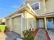 Charming exterior of a home with a garage, front door, and well-maintained landscaping at 11246 Kapok Grand Cir, Madeira Beach, FL 33708