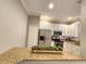 Well-lit kitchen with stainless steel appliances and granite countertops; breakfast bar included at 11246 Kapok Grand Cir, Madeira Beach, FL 33708