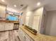 Open concept kitchen and island with granite countertops and views of living space at 11246 Kapok Grand Cir, Madeira Beach, FL 33708