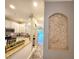 Open-concept kitchen with granite countertops, white cabinetry, and stainless steel appliances at 11246 Kapok Grand Cir, Madeira Beach, FL 33708