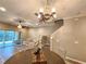 Open-concept living room featuring a dining area, staircase, and sliding glass doors to an outdoor patio at 11246 Kapok Grand Cir, Madeira Beach, FL 33708