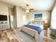 Cozy bedroom with a beach-themed decor, ceiling fan, and ample natural light from the windows at 11246 Kapok Grand Cir, Madeira Beach, FL 33708