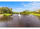 Beautiful pond with fountains and a statue of a Personal in the center at 11246 Kapok Grand Cir, Madeira Beach, FL 33708