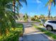 Neighborhood street view showcasing well-maintained landscaping, sidewalks, and charming homes at 11246 Kapok Grand Cir, Madeira Beach, FL 33708