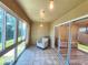 Bright sunroom with tiled floor and large windows; great natural light and additional seating at 11246 Kapok Grand Cir, Madeira Beach, FL 33708