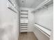 Neatly organized walk-in closet with built-in shelving and ample storage space at 11246 Kapok Grand Cir, Madeira Beach, FL 33708