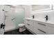 Modern bathroom featuring a double vanity, black hardware, and a glass-enclosed shower at 11350 112Th Ave, Largo, FL 33778