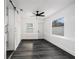 Bright bedroom with a ceiling fan, two windows, stylish wood flooring and barn door closet at 11350 112Th Ave, Largo, FL 33778