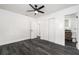 Bright bedroom with dark floors, ceiling fan, and view of an ensuite bathroom is a modern and stylish space at 11350 112Th Ave, Largo, FL 33778