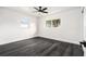 Sunny bedroom with dark floors and two windows that offer ample natural light, perfect for a peaceful retreat at 11350 112Th Ave, Largo, FL 33778