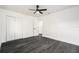 Bedroom with dark floors, ceiling fan, and closet doors offers a comfortable and stylish living space at 11350 112Th Ave, Largo, FL 33778