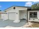 A charming home featuring a one-car garage, well manicured lawn, and stylish exterior lighting at 11350 112Th Ave, Largo, FL 33778