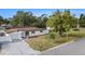 Charming one-story home featuring a manicured lawn, long driveway and established shade trees at 11350 112Th Ave, Largo, FL 33778