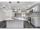 Contemporary kitchen with an island, stainless appliances, stylish backsplash, and modern lighting at 11350 112Th Ave, Largo, FL 33778