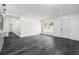 Bright living room with modern flooring, a window view, and freshly painted white walls at 11350 112Th Ave, Largo, FL 33778