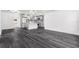 Open concept living space with hardwood floors flowing seamlessly into the adjacent updated kitchen at 11350 112Th Ave, Largo, FL 33778