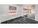 Bright room with dark wood floors and sliding glass doors leading to the outside, offers indoor-outdoor living at 11350 112Th Ave, Largo, FL 33778