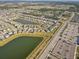 An expansive aerial view of a community with multiple lakes, green spaces, and organized streets at 11476 Sage Canyon Dr, Riverview, FL 33578