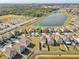 An aerial view of a residential community featuring beautiful homes and a serene lake at 11476 Sage Canyon Dr, Riverview, FL 33578