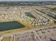 A sprawling residential community with multiple lakes, green spaces, and convenient parking areas, seen from an aerial perspective at 11476 Sage Canyon Dr, Riverview, FL 33578