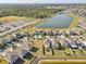 An aerial view of a residential community featuring beautiful homes and a serene lake at 11476 Sage Canyon Dr, Riverview, FL 33578