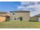 A spacious backyard with a grassy lawn and a view of adjacent houses at 11476 Sage Canyon Dr, Riverview, FL 33578