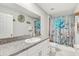 Bathroom featuring a shower, vanity with granite countertops, and decorative elements at 11476 Sage Canyon Dr, Riverview, FL 33578