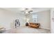 Cozy bedroom with a ceiling fan, window, and comfortable seating area at 11476 Sage Canyon Dr, Riverview, FL 33578