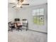 Well-lit bedroom featuring a ceiling fan, window view and a carpeted floor at 11476 Sage Canyon Dr, Riverview, FL 33578