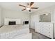 Well-lit bedroom with a bed, dresser, and ceiling fan at 11476 Sage Canyon Dr, Riverview, FL 33578