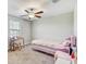 Bedroom with window, desk, pink accents, and a ceiling fan at 11476 Sage Canyon Dr, Riverview, FL 33578